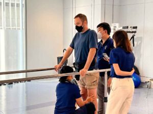 Verita Neuro - Rehabilitation Schedule Post Spinal Cord Injury - Interview With Christian image showing Christian standing during therapy