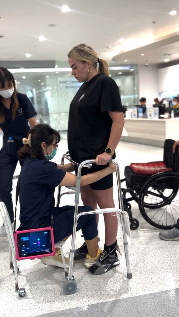 Verita Neuro - Blog - Webinar - From Injury to Independence- A Patient’s Experience with T6 T7 Spinal Cord Injury Treatment - Julia on the walker