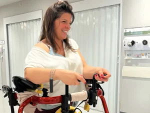 Emmanuelle engaged in assisted walking therapy at Verita Neuro