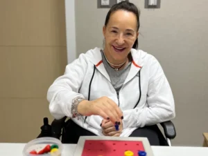 Karen smiling in front of camera after therapy session at Verita Neuro