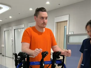 Vuk receiving assisted walking therapy at Verita Neuro